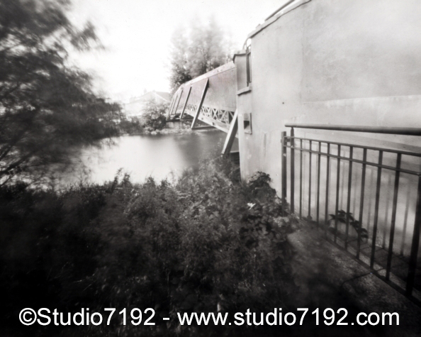 Foot Bridge   Erneside Shopping Centre, River Erne , Enniskillen during the summer, Co. Fermanagh, Northern Ireland. This black and white camera obscura photo is NOT sharp due to camera characteristic. Taken on analogue photographic large format negative film (Ilford) with a pinhole camera, Lerouge 45, #19100475Foot Bridge, Enniskillen # 19100475 